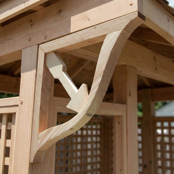 Close-up of a natural wood gazebo or pergola corner with a decorative curved bracket support and lattice paneling.