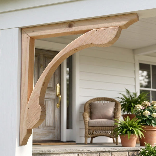 Natural wood corbel mounted on a white porch column, with a wicker chair and potted plants in the background