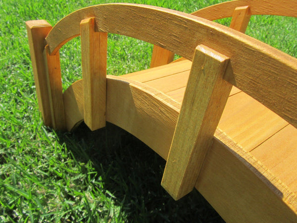 Small Wooden Garden Bridge 25 Inches Tan rail closeup